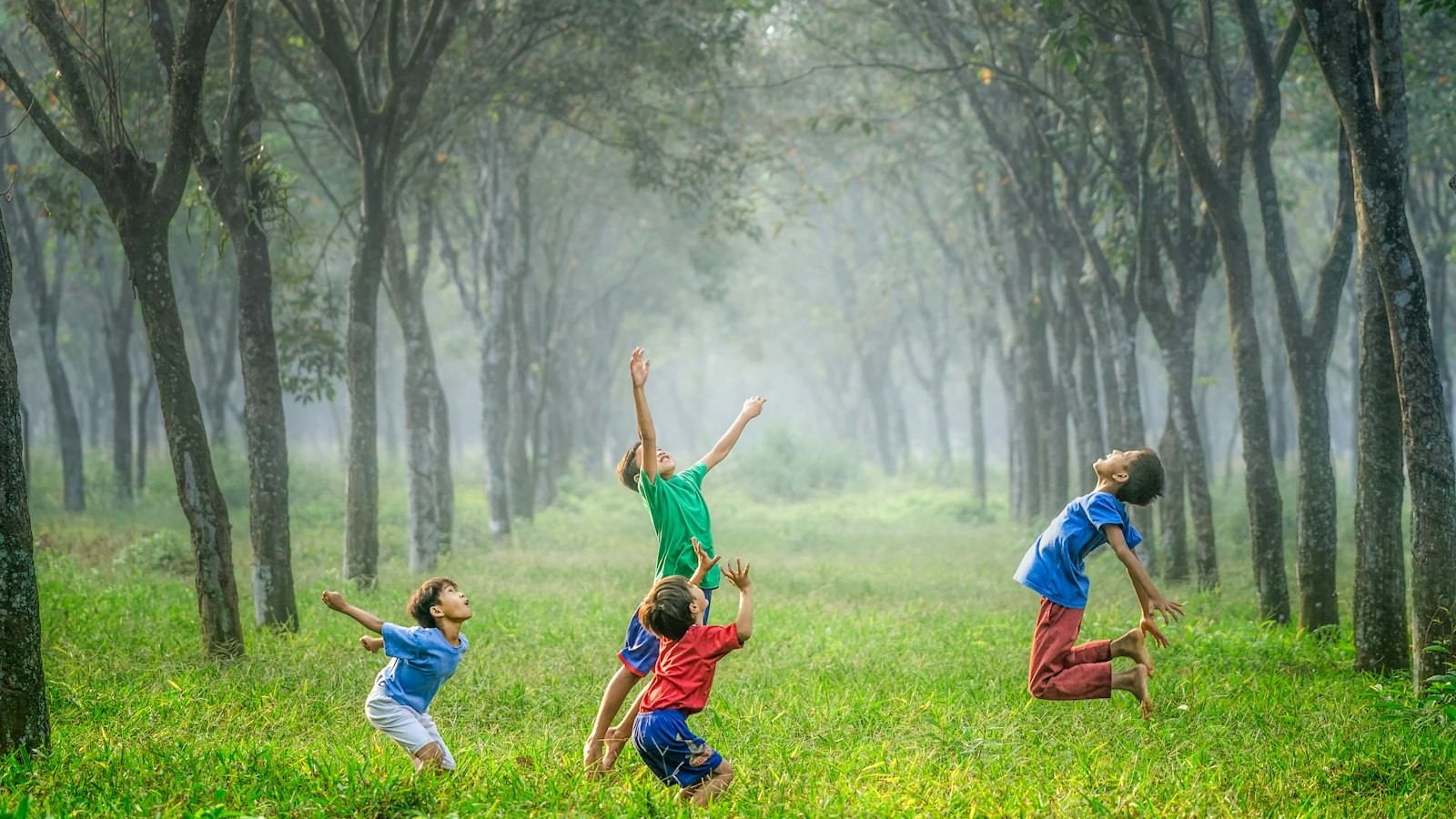 Young people playing together outdoors, representing community, sport and future generations